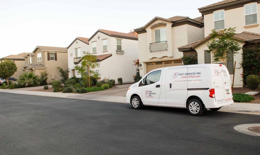 white business van in front of houses