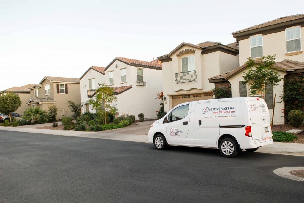 white business van in front of houses